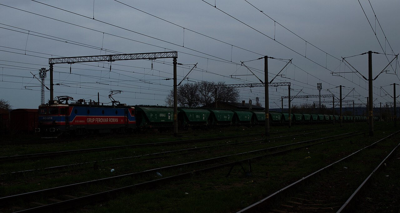 Freight train carrying grain wagons at the Adjud rail yard in Romania